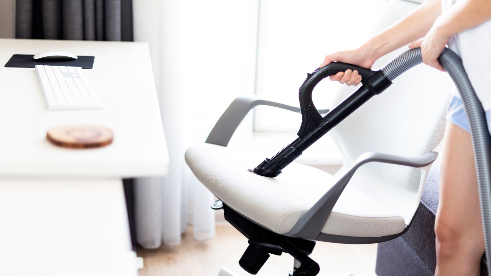 Cleaning an office chair with a vacuum cleaner